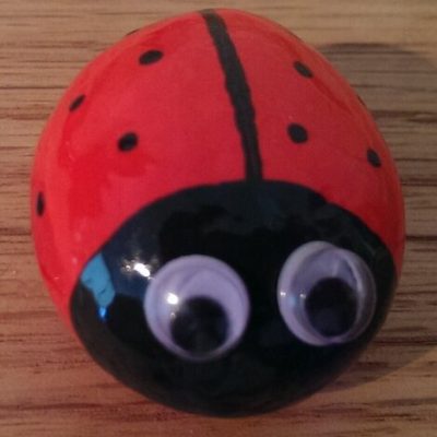 small round rock painted to look like a ladybug