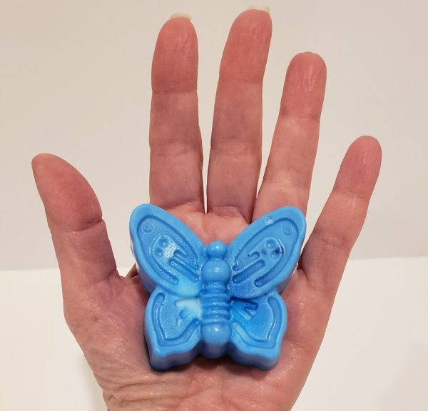 blue soap held in a hand, shaped like a butterfly