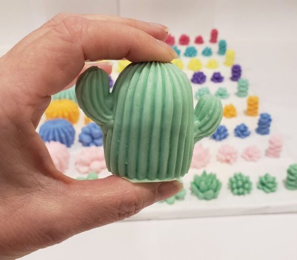 soap shaped like a cactus held in a hand to show scale