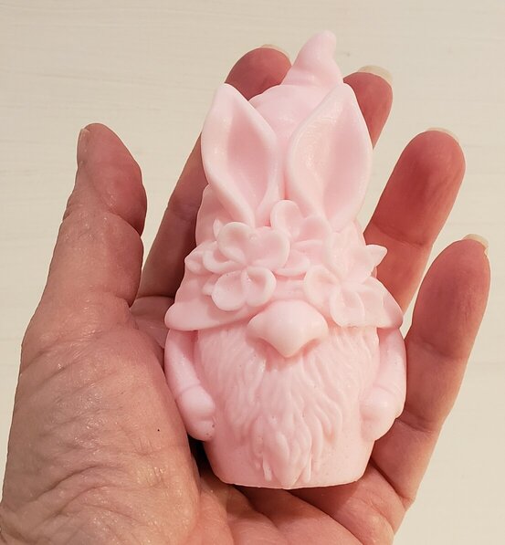 hand holding pink bunny gnome to show size and scale
