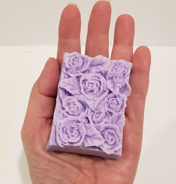rose top soap in hand to show scale