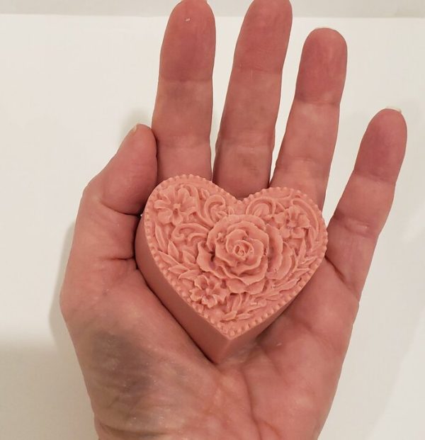 heart shaped soap in hand to show scale