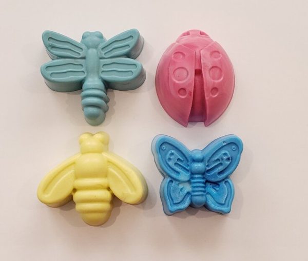 overhead view of 4 soaps shaped like a bee, butterfly, ladybug and dragonfly