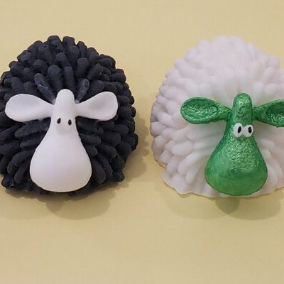 soaps shaped like sheep, including one black sheep and three white with different colored faces